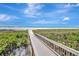 Wooden boardwalk leads to the beach at 5062 Flagstone Dr, Sarasota, FL 34238