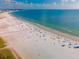 Aerial view of a beach with many people enjoying the sand and water at 5062 Flagstone Dr, Sarasota, FL 34238