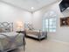 Charming bedroom with twin beds, arched window with shutters, and neutral decor at 5062 Flagstone Dr, Sarasota, FL 34238