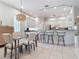 Modern kitchen with breakfast bar and glass-top dining table at 5062 Flagstone Dr, Sarasota, FL 34238