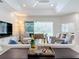 Bright living room with comfortable seating, large TV, and sliding glass doors leading to the pool at 5062 Flagstone Dr, Sarasota, FL 34238