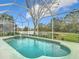 Inviting screened pool with a fountain overlooking a tranquil lake at 5062 Flagstone Dr, Sarasota, FL 34238