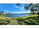Tranquil lake view with lush green grass at 514 Spring Lakes Blvd, Bradenton, FL 34210