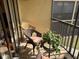 Private screened balcony with wicker chairs and potted plants at 515 30Th W Ave # H207, Bradenton, FL 34205