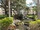 Peaceful courtyard with a fountain and lush landscaping at 515 30Th W Ave # H207, Bradenton, FL 34205