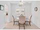 Cozy dining area with glass-top table and four chairs, near kitchen at 521 W Venice Ave # 22, Venice, FL 34285