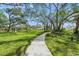 Paved pathway winds through lush green landscape, offering scenic community views at 5803 Garden Lakes Majestic # 145, Bradenton, FL 34203