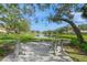 Relaxing waterfront view with benches, ideal for peaceful moments at 5803 Garden Lakes Majestic # 145, Bradenton, FL 34203