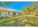 Spacious backyard with lush green grass and trees at 5803 Garden Lakes Palm, Bradenton, FL 34203