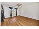 Bedroom with wood-look floors, ceiling fan, and access to a patio at 5803 Garden Lakes Palm, Bradenton, FL 34203