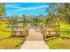 Community dock with seating overlooking a pond at 5803 Garden Lakes Palm, Bradenton, FL 34203