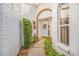 Front entry with arched doorway and landscaped walkway at 5803 Garden Lakes Palm, Bradenton, FL 34203