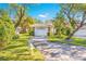 White brick home with attached garage and lush green lawn at 5803 Garden Lakes Palm, Bradenton, FL 34203
