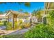 House exterior with lush landscaping and walkway at 5803 Garden Lakes Palm, Bradenton, FL 34203