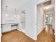 Clean hallway with wood-look floors and access to other rooms at 5803 Garden Lakes Palm, Bradenton, FL 34203