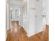 Hallway with wood-look floors and linen closet at 5803 Garden Lakes Palm, Bradenton, FL 34203