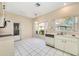 Kitchen features white cabinets, stainless steel appliances, and tiled floors at 5803 Garden Lakes Palm, Bradenton, FL 34203