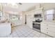 Bright kitchen with stainless steel appliances and white cabinetry at 5803 Garden Lakes Palm, Bradenton, FL 34203