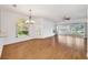 Open living room featuring wood floors and access to a sunroom at 5803 Garden Lakes Palm, Bradenton, FL 34203