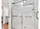 Walk-in shower with grab bars and glass door at 5803 Garden Lakes Palm, Bradenton, FL 34203