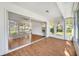 Bright sunroom with wood-look floors and sliding glass doors leading to the backyard at 5803 Garden Lakes Palm, Bradenton, FL 34203