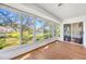 Sunroom with wood floors and pond views at 5803 Garden Lakes Palm, Bradenton, FL 34203