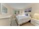 Comfortable bedroom with a full bed, dresser, and artwork at 5938 Welcome Rd # H22, Bradenton, FL 34207