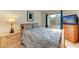 Cozy bedroom with wood furniture and patterned bedding at 5938 Welcome Rd # H22, Bradenton, FL 34207