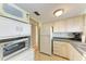 Full kitchen with refrigerator, oven, and countertop at 5938 Welcome Rd # H22, Bradenton, FL 34207