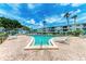 Community pool with lounge chairs and brick patio at 5938 Welcome Rd # H22, Bradenton, FL 34207