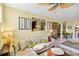 Light-filled living room features a beige couch, wood coffee table, and built-in shelving at 5940 Briarwood Ave, Sarasota, FL 34231