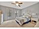 Main bedroom with king-size bed, private access to patio, and ceiling fan at 5972 Giardino Ln, Sarasota, FL 34232