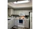 Kitchen with white appliances and light cabinets at 6304 Pointe West Blvd # A203, Bradenton, FL 34209