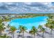 Aerial view of crystal-clear lagoon, homes, and palm trees at 6404 Pigeon Plum Way, Bradenton, FL 34210