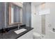 Modern bathroom with dark vanity and white tile at 6404 Pigeon Plum Way, Bradenton, FL 34210