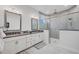 Spa-like bathroom with double vanity, large shower, and grey tile at 6404 Pigeon Plum Way, Bradenton, FL 34210