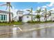 White modern home with palm trees and a landscaped yard at 6404 Pigeon Plum Way, Bradenton, FL 34210