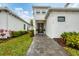 Modern home's entrance with walkway and landscaping at 6404 Pigeon Plum Way, Bradenton, FL 34210