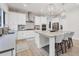 Modern kitchen with white cabinets, island, and stone backsplash at 6404 Pigeon Plum Way, Bradenton, FL 34210