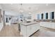 Bright kitchen features a large island, white cabinets, and hardwood floors at 6404 Pigeon Plum Way, Bradenton, FL 34210