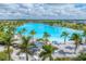 Lagoon-style pool with sandy beach and palm trees at 6404 Pigeon Plum Way, Bradenton, FL 34210