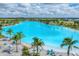 Expansive crystal lagoon with surrounding palm trees at 6404 Pigeon Plum Way, Bradenton, FL 34210