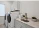 Laundry room with quartz countertop and cabinets at 6404 Pigeon Plum Way, Bradenton, FL 34210