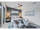 Serene main bedroom with a ceiling fan, gray accent wall, and sitting area at 6404 Pigeon Plum Way, Bradenton, FL 34210