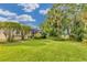 Private backyard with lush landscaping and water view at 6650 Cheswick St, Sarasota, FL 34243