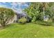 Landscaped backyard with lush greenery and screened patio at 6650 Cheswick St, Sarasota, FL 34243