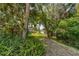 Peaceful path leading to a tranquil waterfront view at 6650 Cheswick St, Sarasota, FL 34243