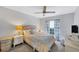 Bedroom with a comfortable bed, nightstands and ceiling fan at 6650 Cheswick St, Sarasota, FL 34243