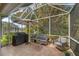 Enjoy this large screened patio with seating and a grill at 6650 Cheswick St, Sarasota, FL 34243