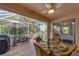 Spacious screened-in patio with seating area and outdoor grill at 6650 Cheswick St, Sarasota, FL 34243